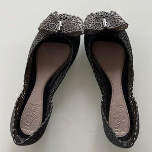 A playful take on Ferragamo's staple bow-trimmed silhouette rendered in PVC.